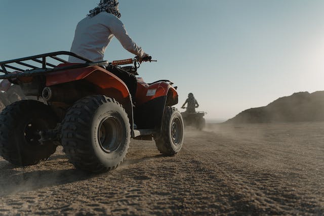 people riding ATVs