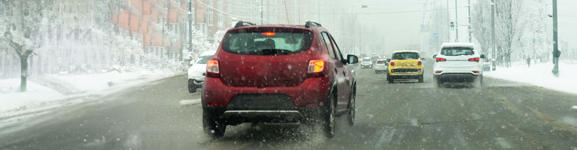A car swerving down an icy snowy road - Kane County Car Accident Lawyer concept image