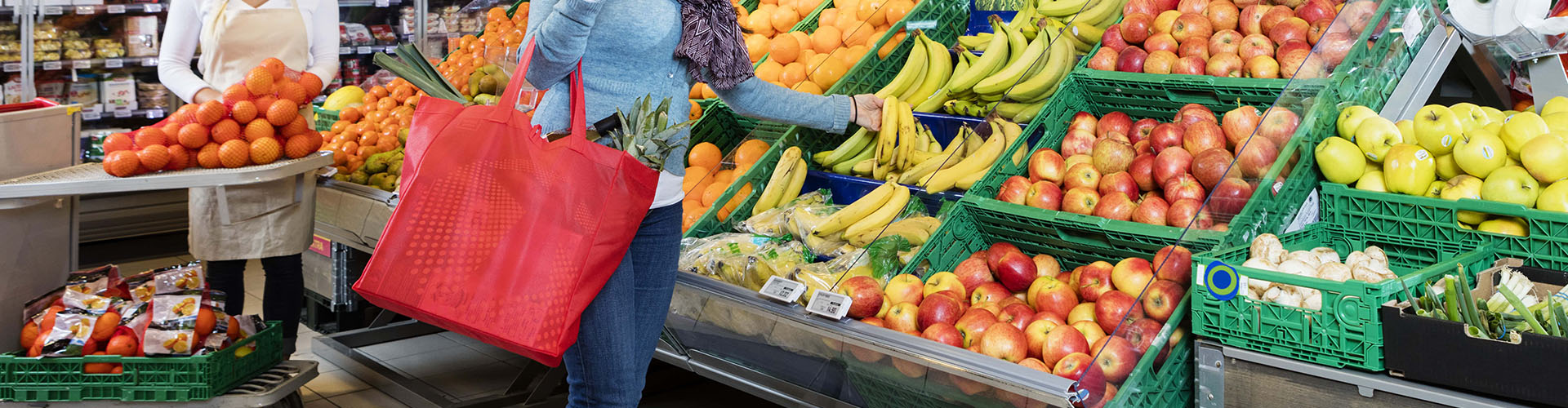 customer buying fresh bananas in grocery shop