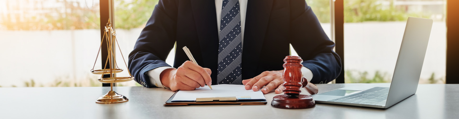 man in suit signing documents