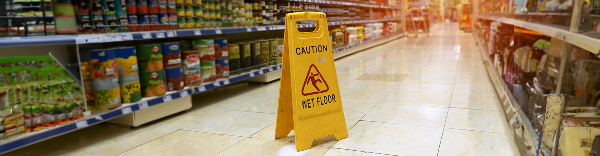 A wet supermarket floor with Caution 