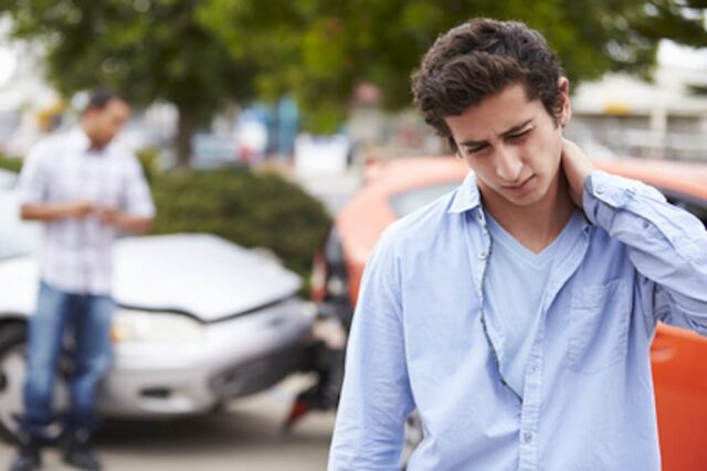 man holding neck in front of collision