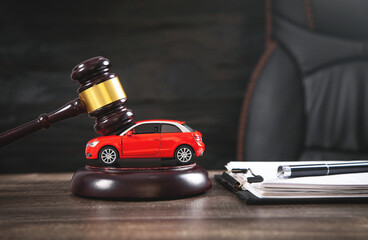 small car and gavel with paperwork